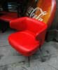 A couple of red leather armchair with iron legs